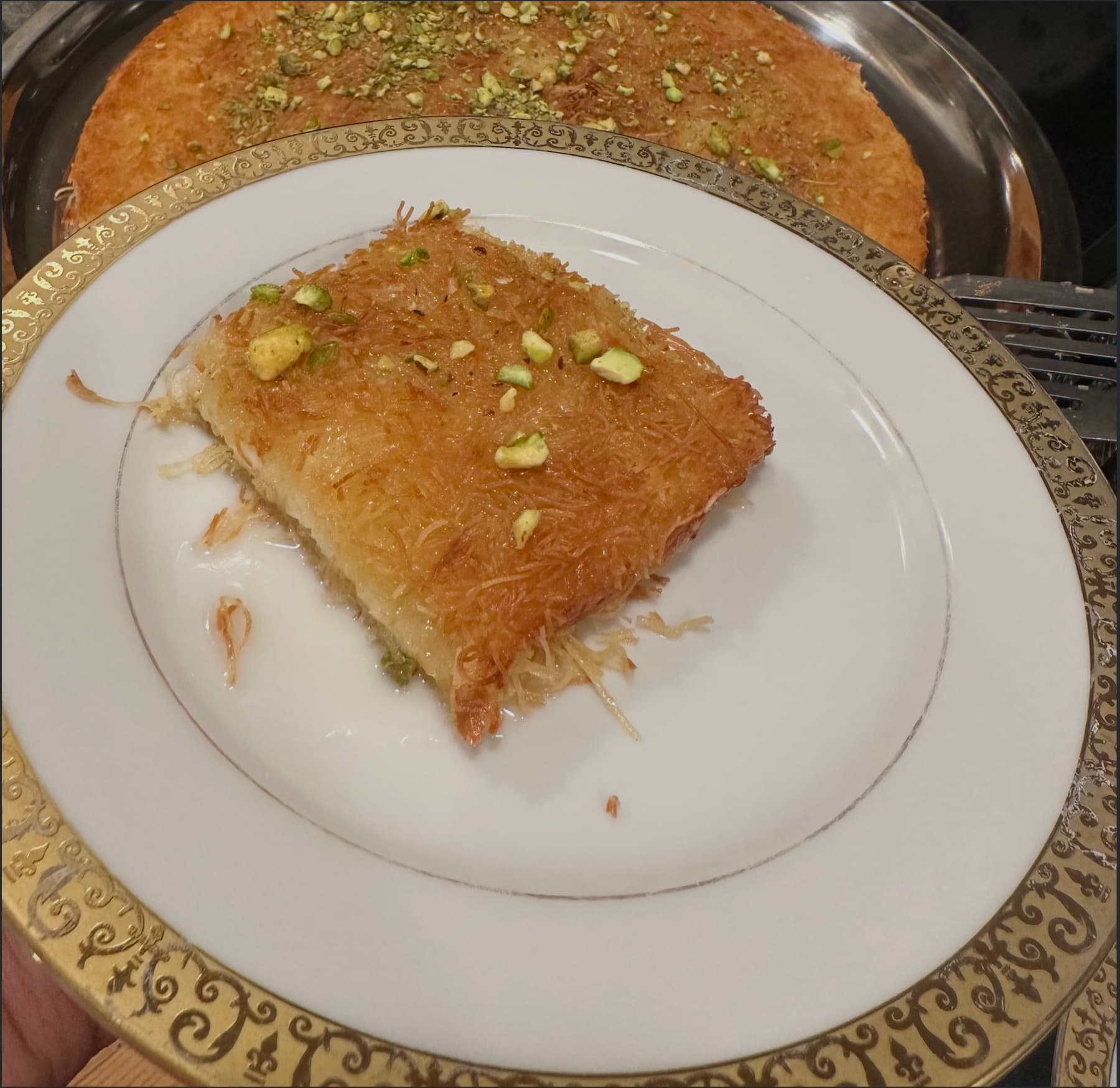 A warm slice of syrup-soaked knafe plated and ready to eat